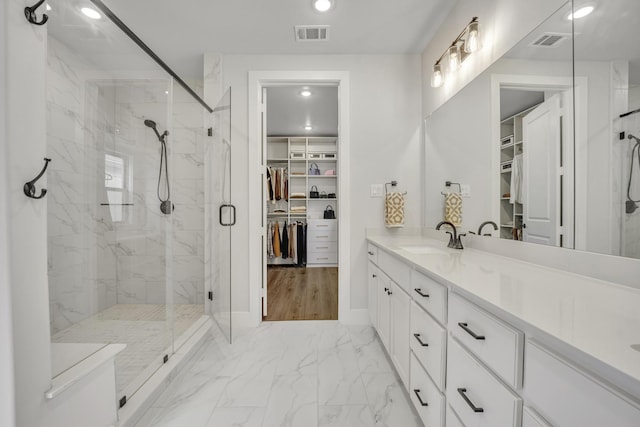 bathroom featuring an enclosed shower and vanity