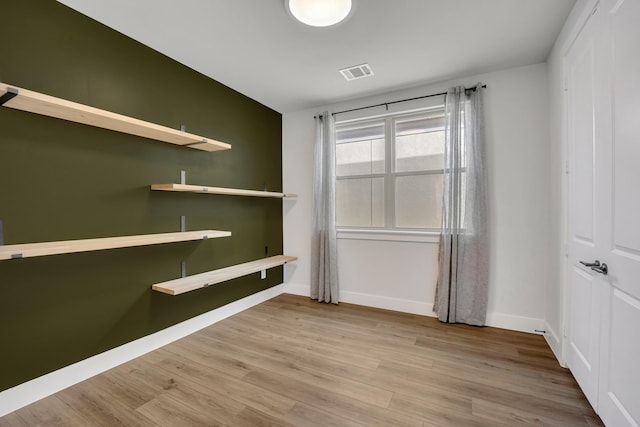 unfurnished room featuring hardwood / wood-style floors