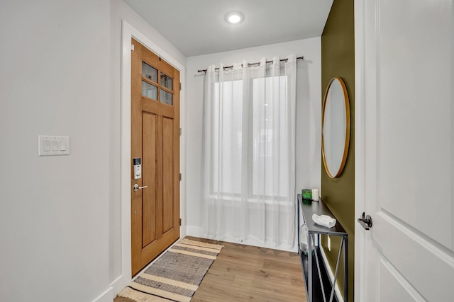 foyer featuring light hardwood / wood-style flooring and a healthy amount of sunlight