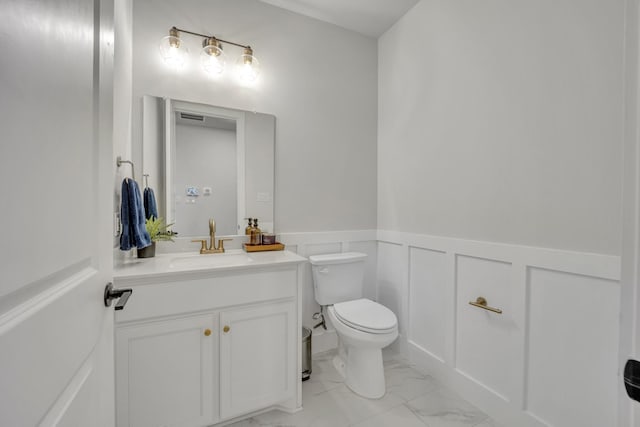 bathroom featuring toilet and vanity