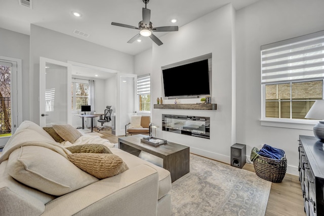 living room featuring ceiling fan and light wood-type flooring