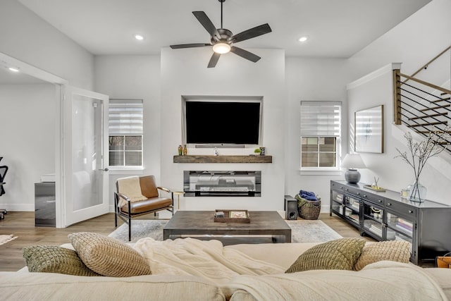 living room featuring light wood-type flooring and ceiling fan