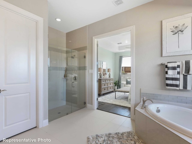 bathroom with separate shower and tub and tile patterned floors