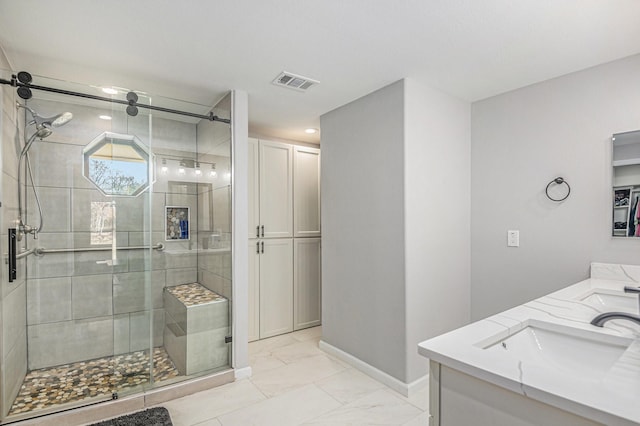 bathroom with a shower with shower door and vanity