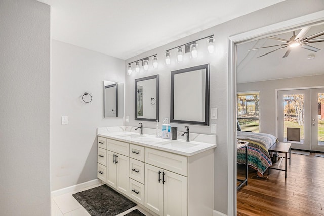 bathroom featuring ceiling fan, french doors, and vanity