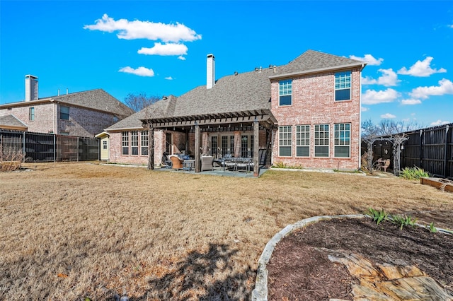 back of house featuring a patio, a yard, and a pergola