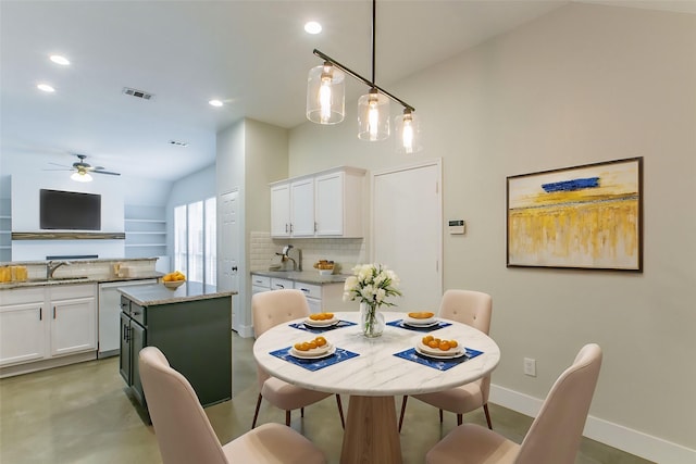 dining room with ceiling fan and sink