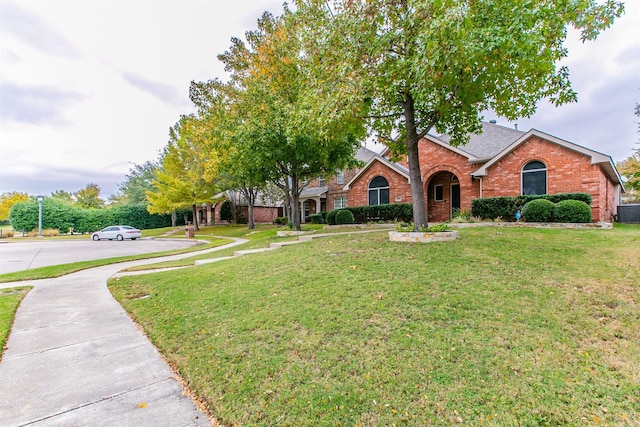 view of front of property with central AC unit and a front yard