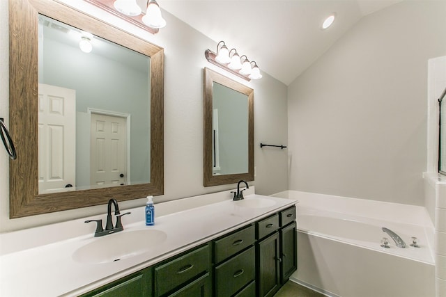 bathroom with a bathing tub, vanity, and lofted ceiling