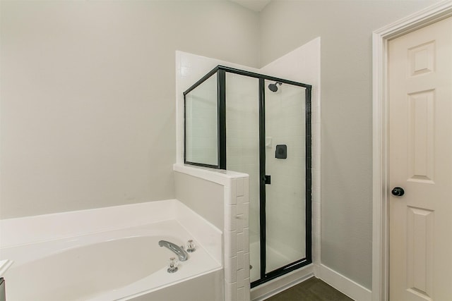 bathroom featuring separate shower and tub