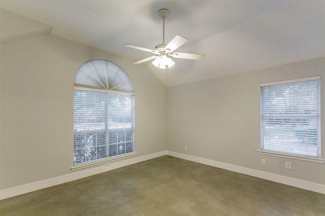 empty room with ceiling fan and vaulted ceiling