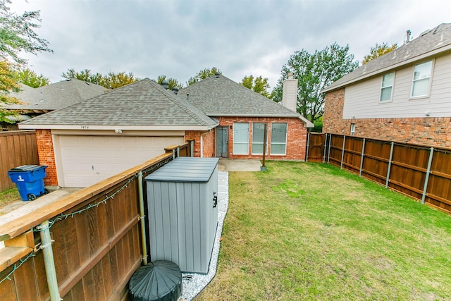 view of yard with a shed and a garage