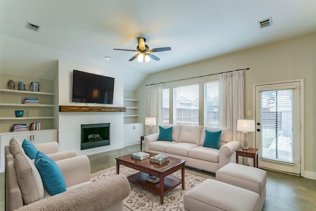 living room featuring ceiling fan, built in features, and vaulted ceiling