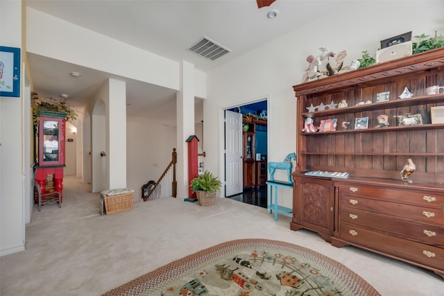 sitting room featuring light colored carpet