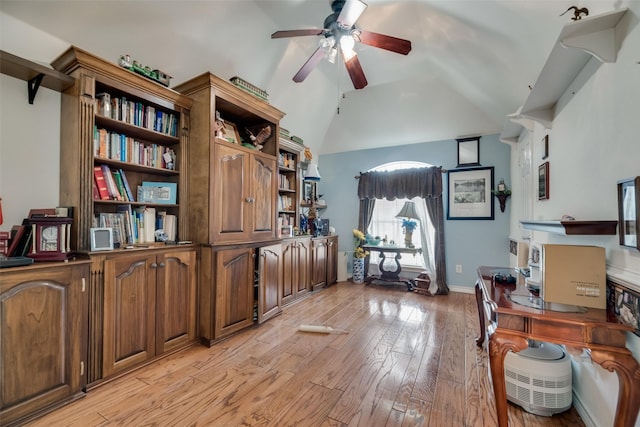 office featuring ceiling fan, light hardwood / wood-style floors, and vaulted ceiling