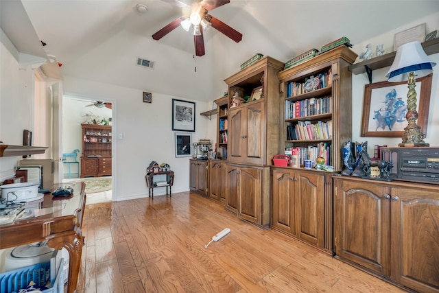 office featuring lofted ceiling, ceiling fan, and light wood-type flooring