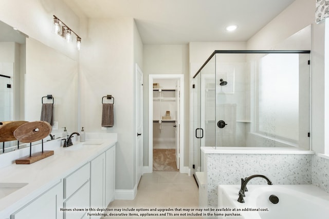 bathroom featuring shower with separate bathtub, vanity, and tile patterned floors