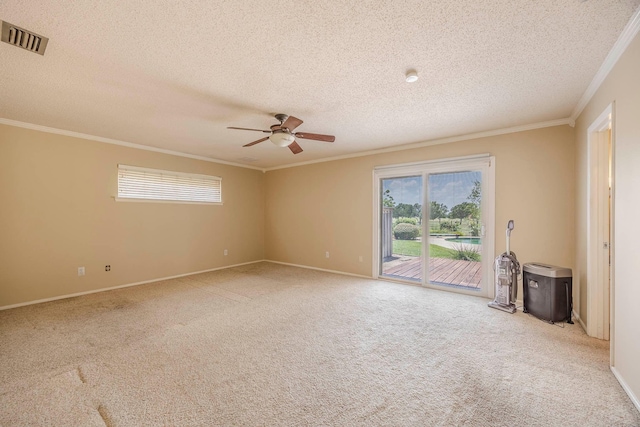 unfurnished room featuring carpet, a textured ceiling, ceiling fan, and ornamental molding