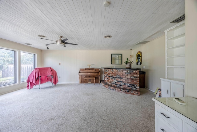 miscellaneous room featuring light carpet, ceiling fan, and wood ceiling