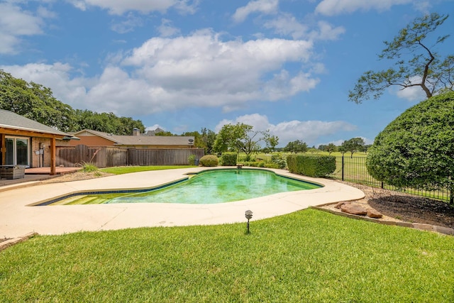 view of pool with a lawn and a patio area