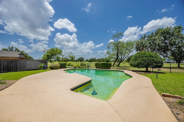 view of pool with a patio area and a lawn