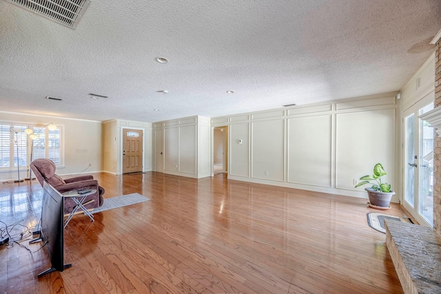 living room featuring a textured ceiling and light hardwood / wood-style floors