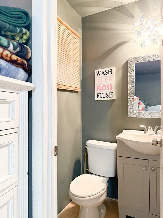 bathroom featuring tile patterned flooring, vanity, and toilet