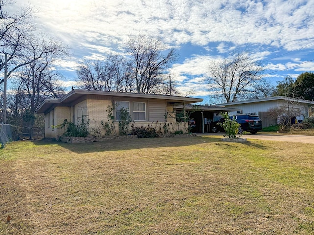 ranch-style home with a front yard and a carport