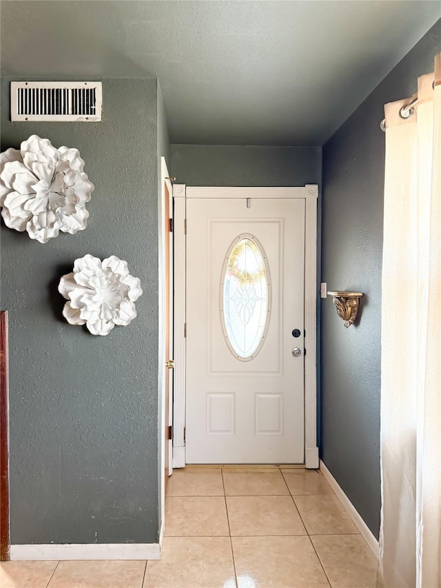 doorway to outside featuring light tile patterned floors