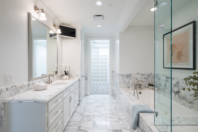 bathroom featuring vanity, ornamental molding, and tiled tub