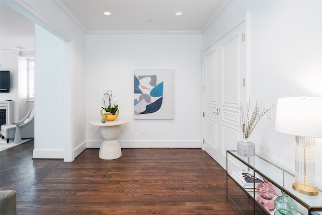 hall with dark hardwood / wood-style floors and ornamental molding