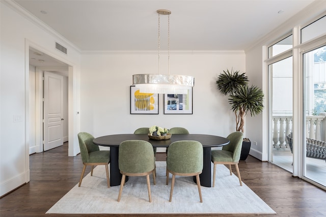 dining space featuring ornamental molding and dark wood-type flooring