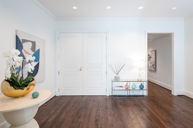 hall with dark hardwood / wood-style floors and ornamental molding