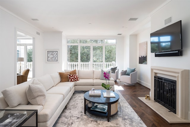 living room featuring crown molding, plenty of natural light, and dark hardwood / wood-style floors