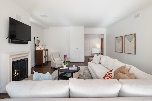 living room featuring dark hardwood / wood-style flooring and crown molding