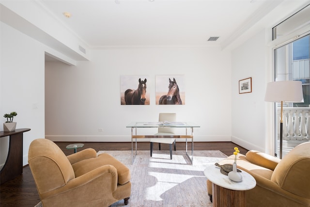 living room featuring dark hardwood / wood-style flooring and crown molding