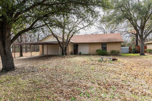 view of front of home with a garage and a carport