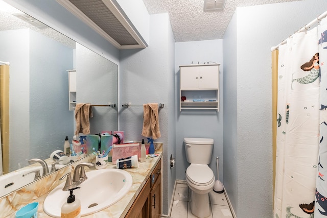 bathroom with vanity, a textured ceiling, toilet, and tile patterned flooring