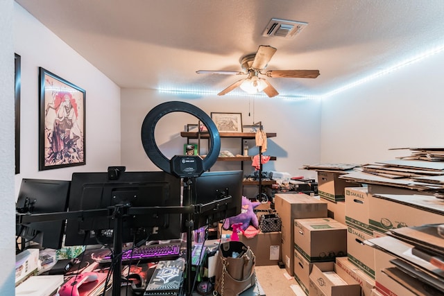 interior space with ceiling fan