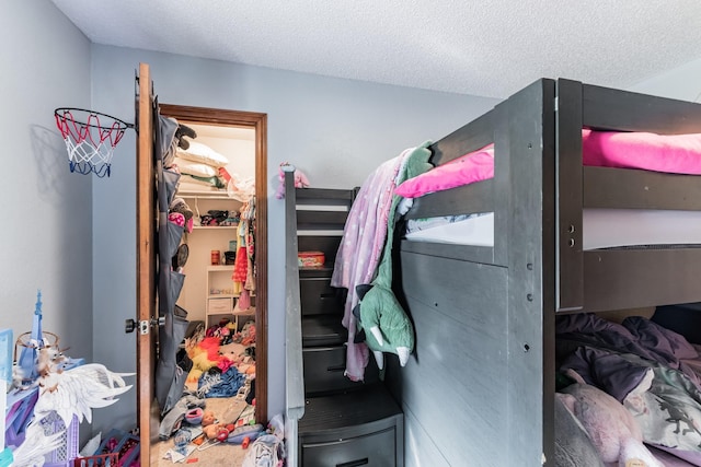 bedroom featuring a textured ceiling and a closet