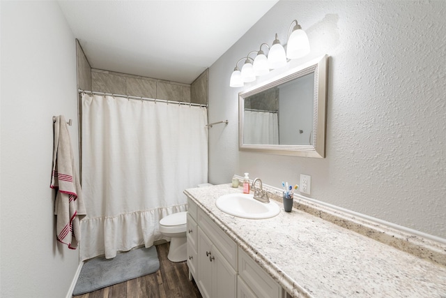 bathroom with a shower with curtain, hardwood / wood-style floors, vanity, and toilet