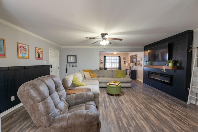 living room with a fireplace, dark hardwood / wood-style floors, ceiling fan, and ornamental molding