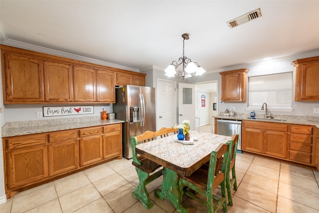 kitchen with an inviting chandelier, crown molding, sink, appliances with stainless steel finishes, and decorative light fixtures