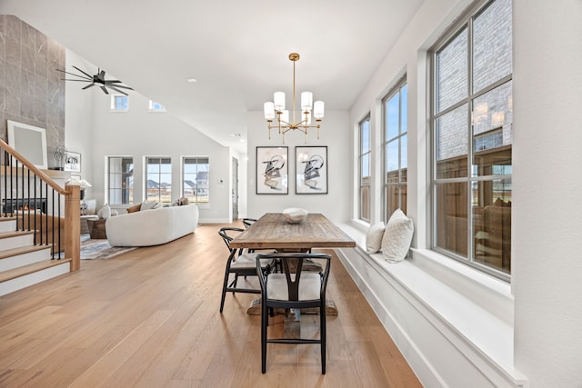 dining area with ceiling fan with notable chandelier and light wood-type flooring