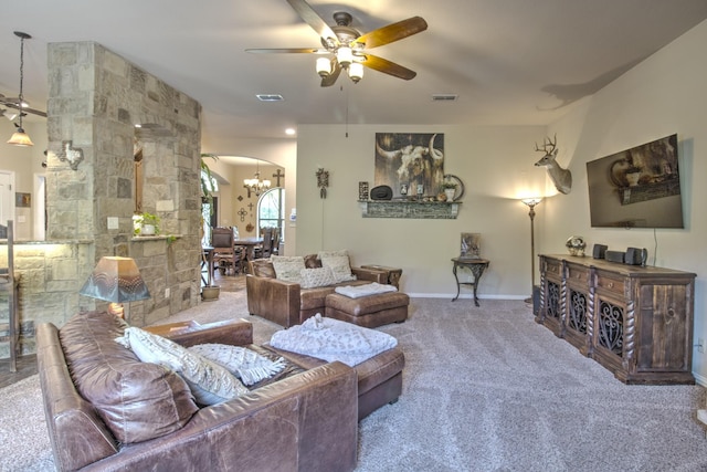 living room featuring ceiling fan with notable chandelier and carpet flooring