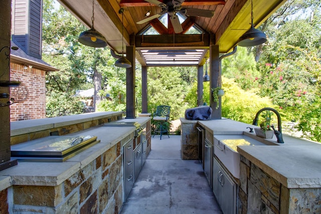 view of patio with area for grilling and ceiling fan