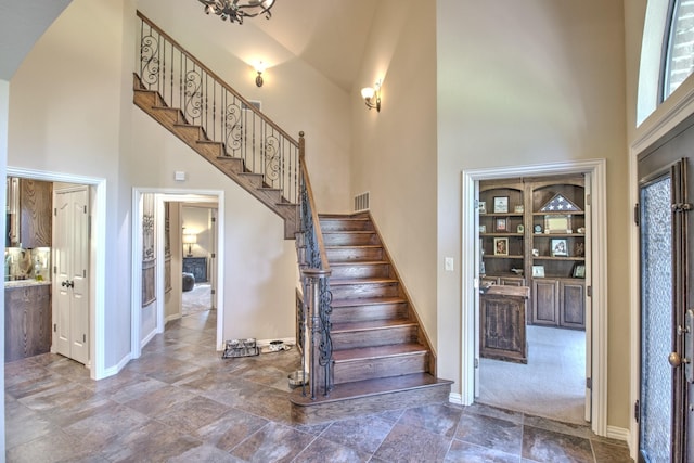 staircase featuring a towering ceiling