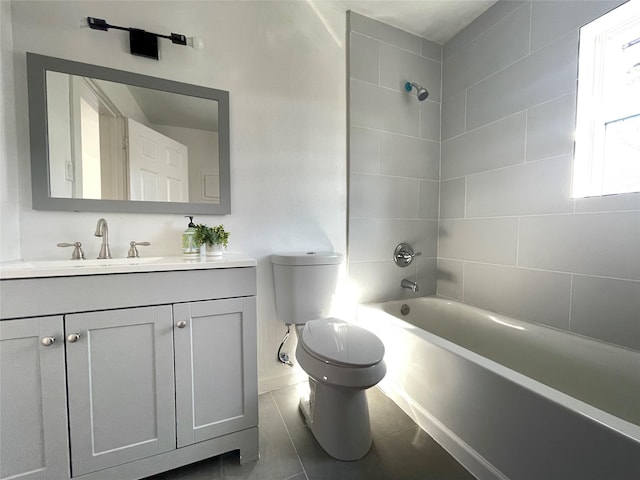 full bathroom featuring vanity, tiled shower / bath combo, and toilet