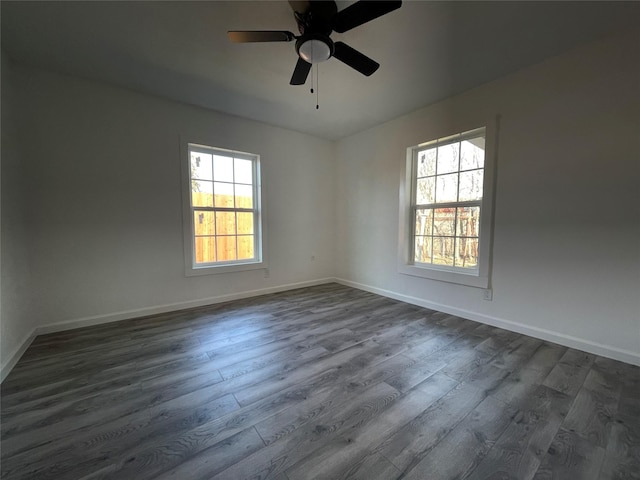 spare room featuring ceiling fan and dark hardwood / wood-style floors