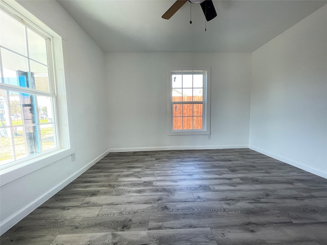 spare room featuring dark hardwood / wood-style floors and ceiling fan